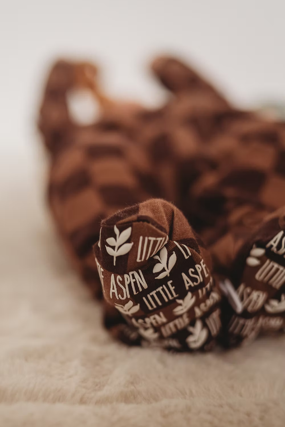 Little Aspen Baby Co - Espresso Checkers Footed Sleeper